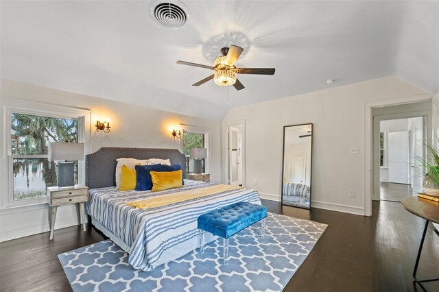 bedroom featuring dark wood-type flooring, ceiling fan, and vaulted ceiling