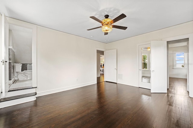 unfurnished bedroom with dark wood-style floors, visible vents, ceiling fan, cooling unit, and baseboards