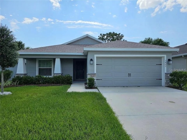 single story home with a garage and a front lawn