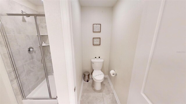 bathroom with walk in shower, tile patterned floors, and toilet