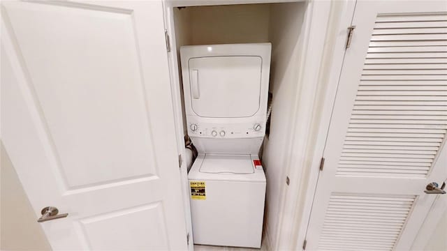 laundry room featuring stacked washer / dryer