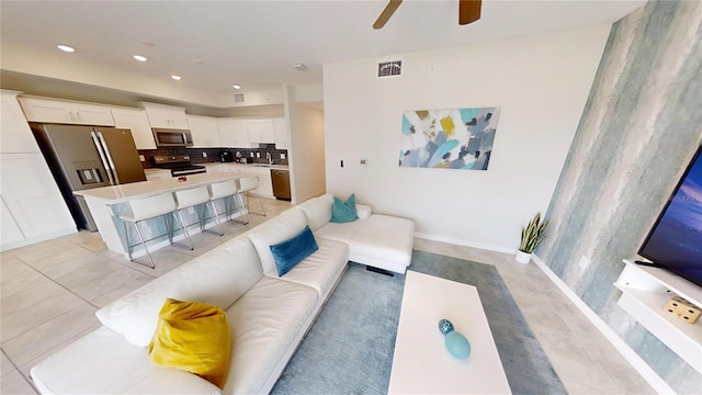 living room featuring light tile patterned flooring and ceiling fan