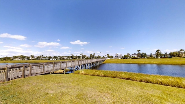 dock area featuring a water view and a yard