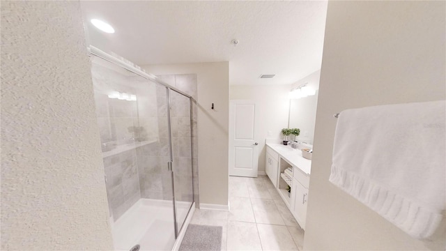 bathroom featuring walk in shower, tile patterned floors, and vanity