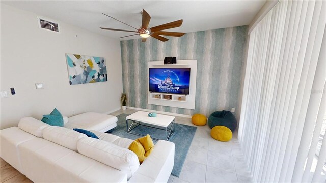 tiled living room with ceiling fan