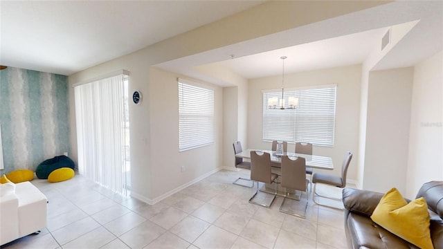 tiled dining space with a notable chandelier