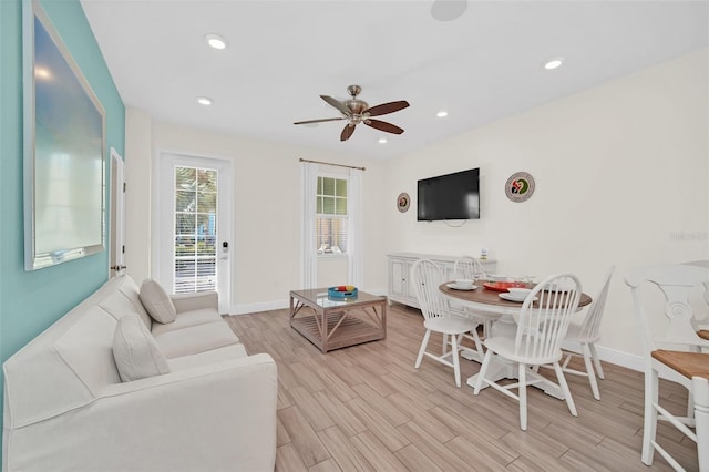 living room with ceiling fan and light wood-type flooring