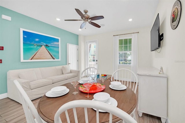 dining space featuring light hardwood / wood-style floors and ceiling fan