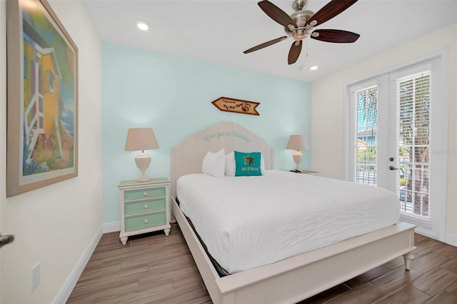 bedroom with hardwood / wood-style flooring, french doors, access to outside, and ceiling fan