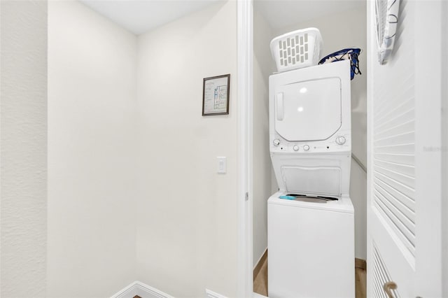 clothes washing area featuring stacked washer and dryer