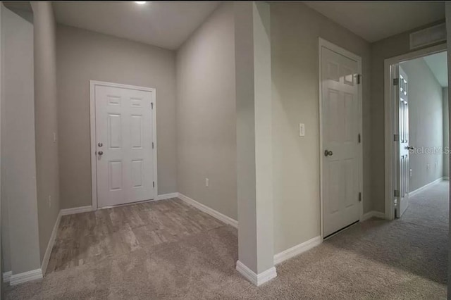 hallway with light colored carpet