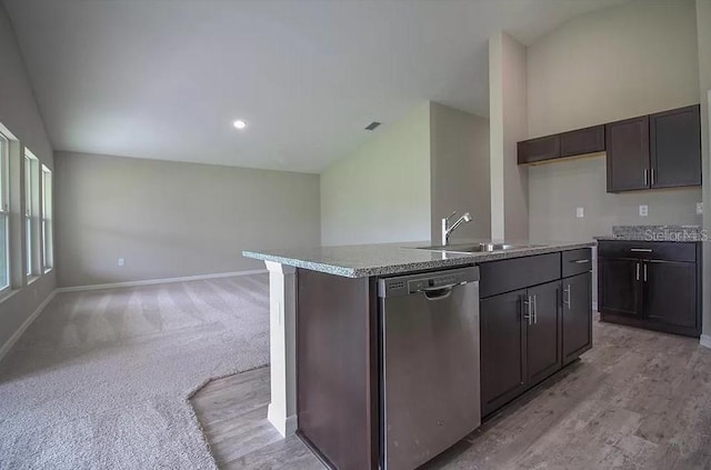 kitchen featuring vaulted ceiling, dishwasher, sink, a kitchen island with sink, and dark brown cabinets