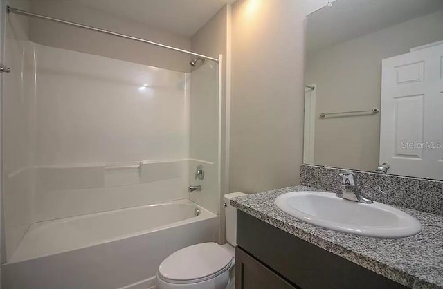 full bathroom featuring vanity, bathing tub / shower combination, and toilet