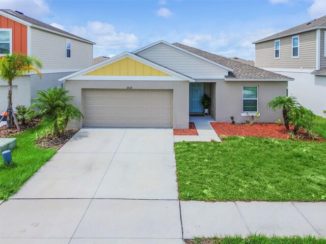 view of front of house with a front lawn and a garage