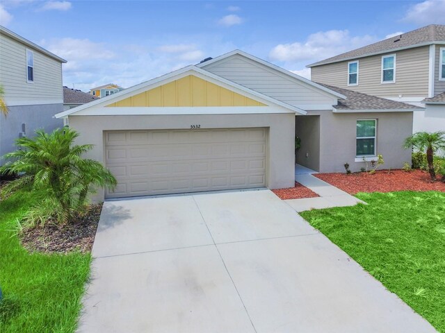 view of front of property with a garage and a front lawn