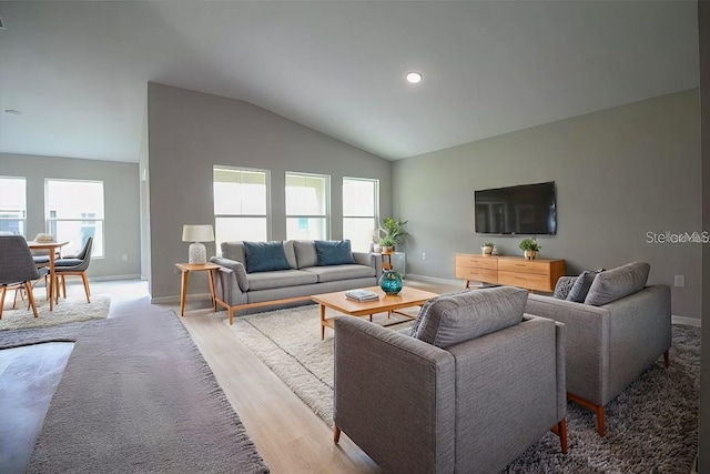 living room with lofted ceiling and light hardwood / wood-style floors