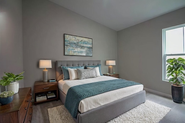 bedroom featuring lofted ceiling and carpet flooring