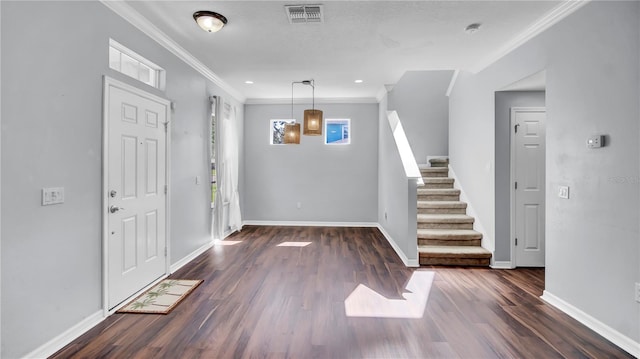 entrance foyer featuring ornamental molding and dark wood-type flooring