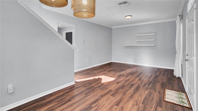 empty room featuring crown molding and dark hardwood / wood-style floors