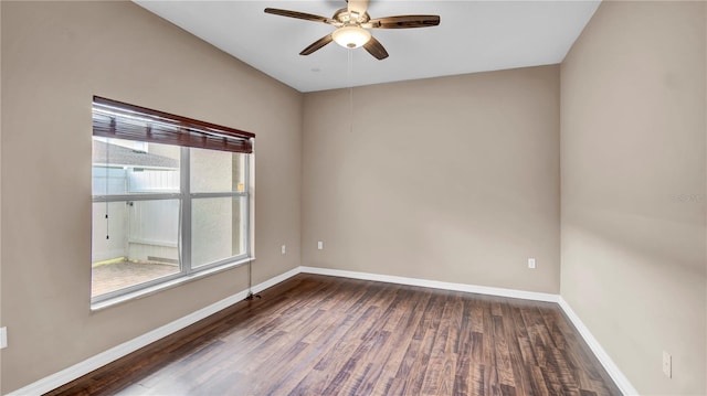 empty room featuring ceiling fan and dark hardwood / wood-style flooring
