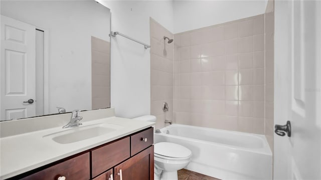 full bathroom with vanity, tile patterned flooring, toilet, and tiled shower / bath