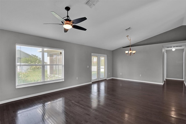 spare room featuring vaulted ceiling, ceiling fan with notable chandelier, dark hardwood / wood-style flooring, and french doors