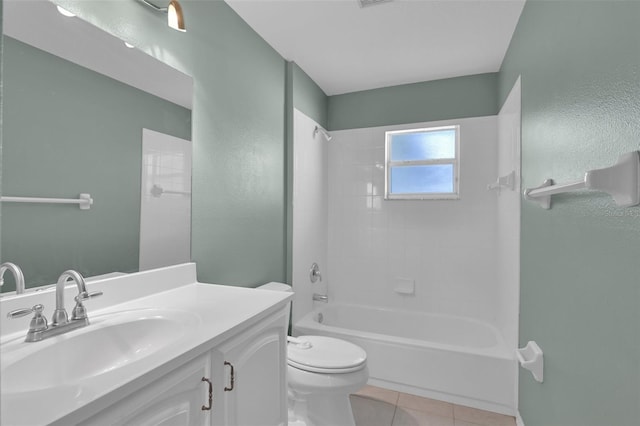 full bathroom with tile patterned flooring, vanity, tiled shower / bath combo, and toilet