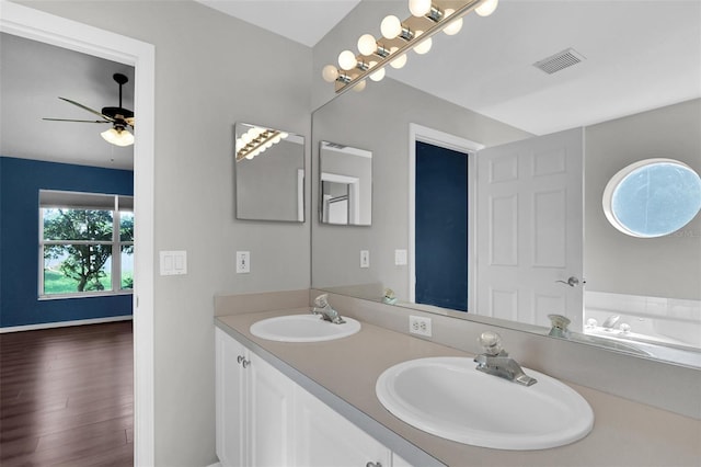 bathroom with vanity, hardwood / wood-style floors, a washtub, and ceiling fan