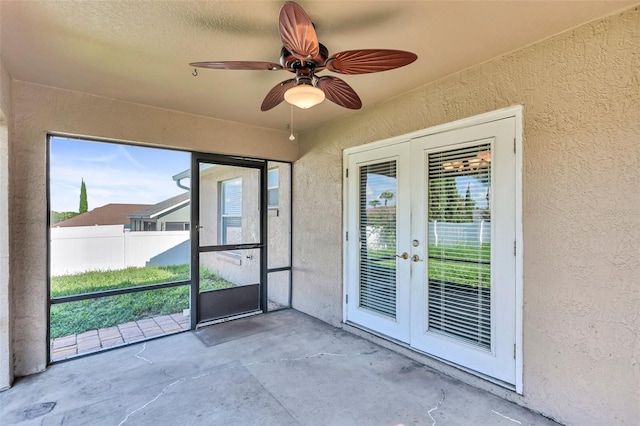 unfurnished sunroom featuring french doors and ceiling fan