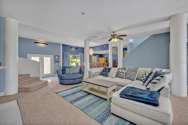 carpeted living room featuring ceiling fan, french doors, and a textured ceiling