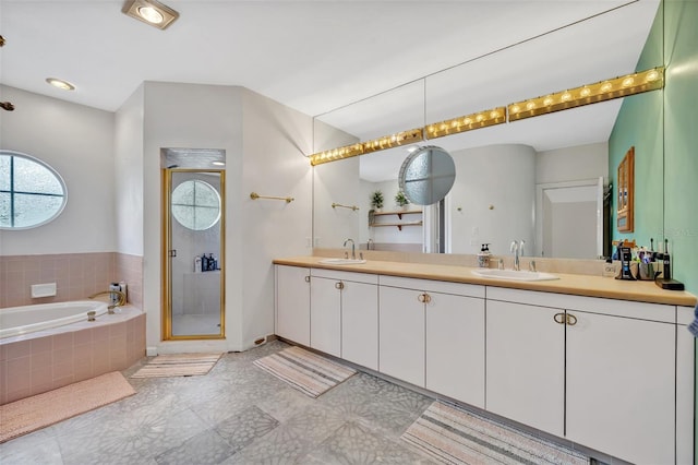 bathroom with plus walk in shower, tile patterned floors, and vanity