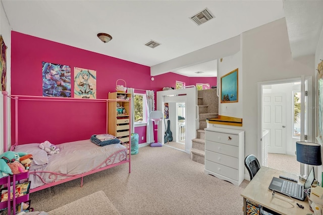 bedroom featuring ensuite bathroom, carpet, and beamed ceiling