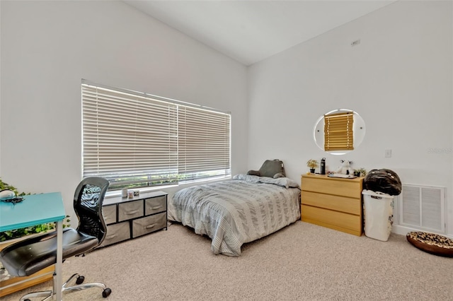 carpeted bedroom with vaulted ceiling