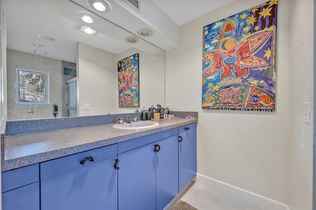 bathroom featuring an enclosed shower, vanity, and tile patterned flooring