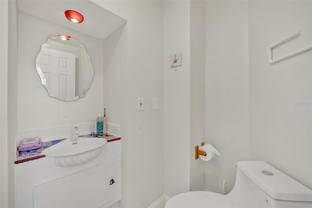 bathroom featuring toilet and vanity