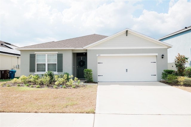 single story home with a garage and a front yard