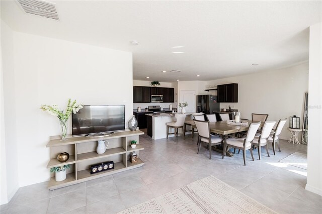 dining space featuring light tile patterned flooring