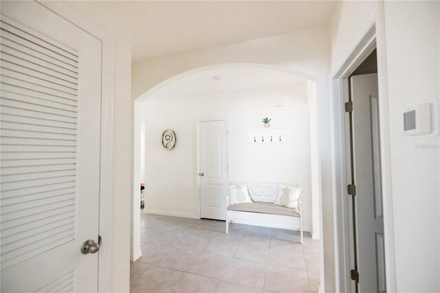 corridor featuring light tile patterned floors