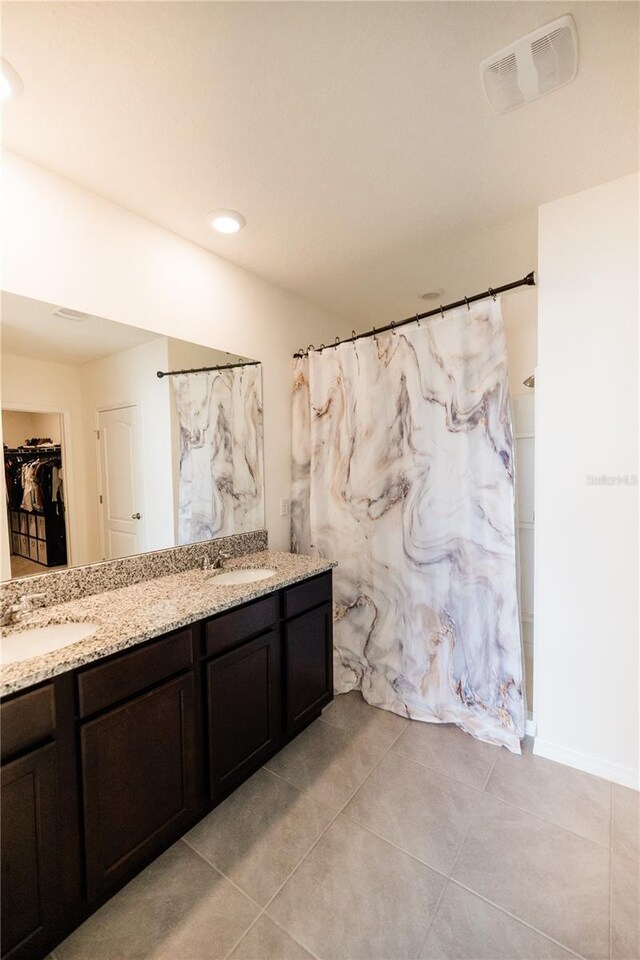 bathroom featuring double vanity and tile patterned floors