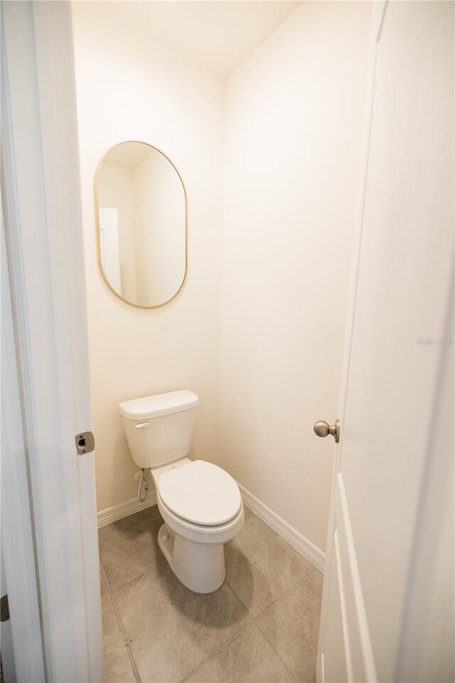 bathroom featuring tile patterned flooring and toilet