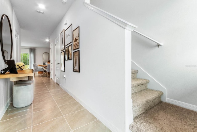 hall featuring light tile patterned floors