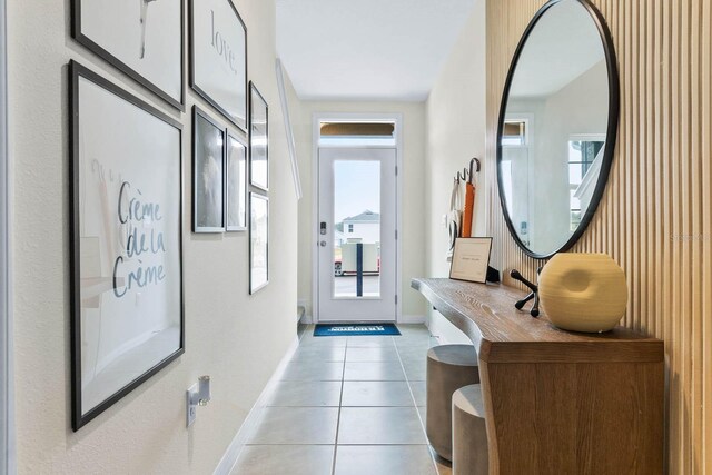 doorway to outside with light tile patterned floors