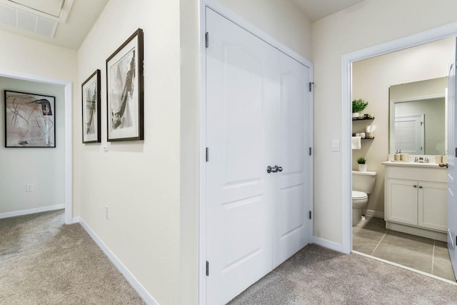 hall with light colored carpet