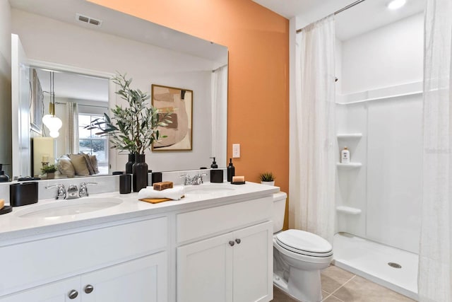 bathroom featuring toilet, a shower with shower curtain, tile patterned flooring, and vanity