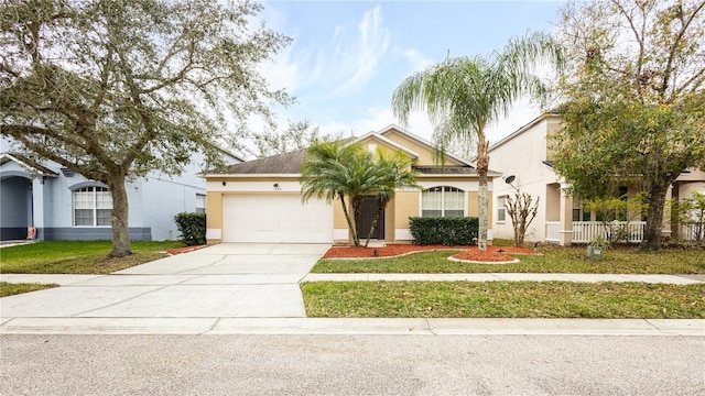 view of front of property featuring a front lawn and a garage