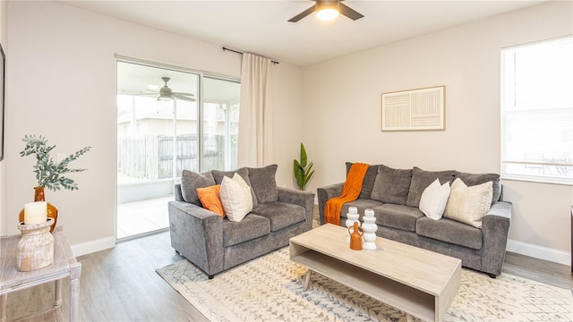 living room featuring light wood-type flooring and ceiling fan