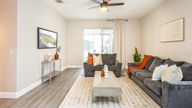 living room featuring ceiling fan and light hardwood / wood-style floors