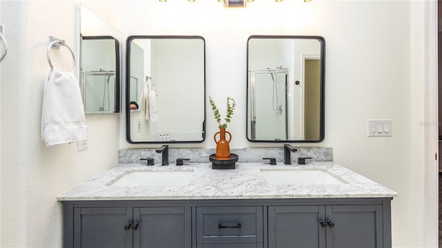 bathroom with a shower with door and vanity