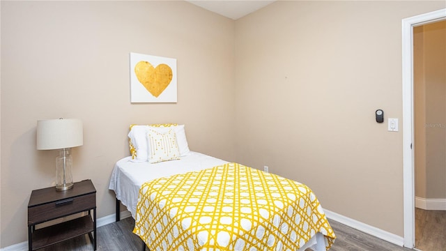 bedroom with dark hardwood / wood-style floors