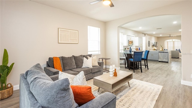 living room featuring light hardwood / wood-style floors and ceiling fan